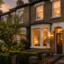 UK semi-detached home with lamps glowing in the evening while the owners are away on holiday mydome security